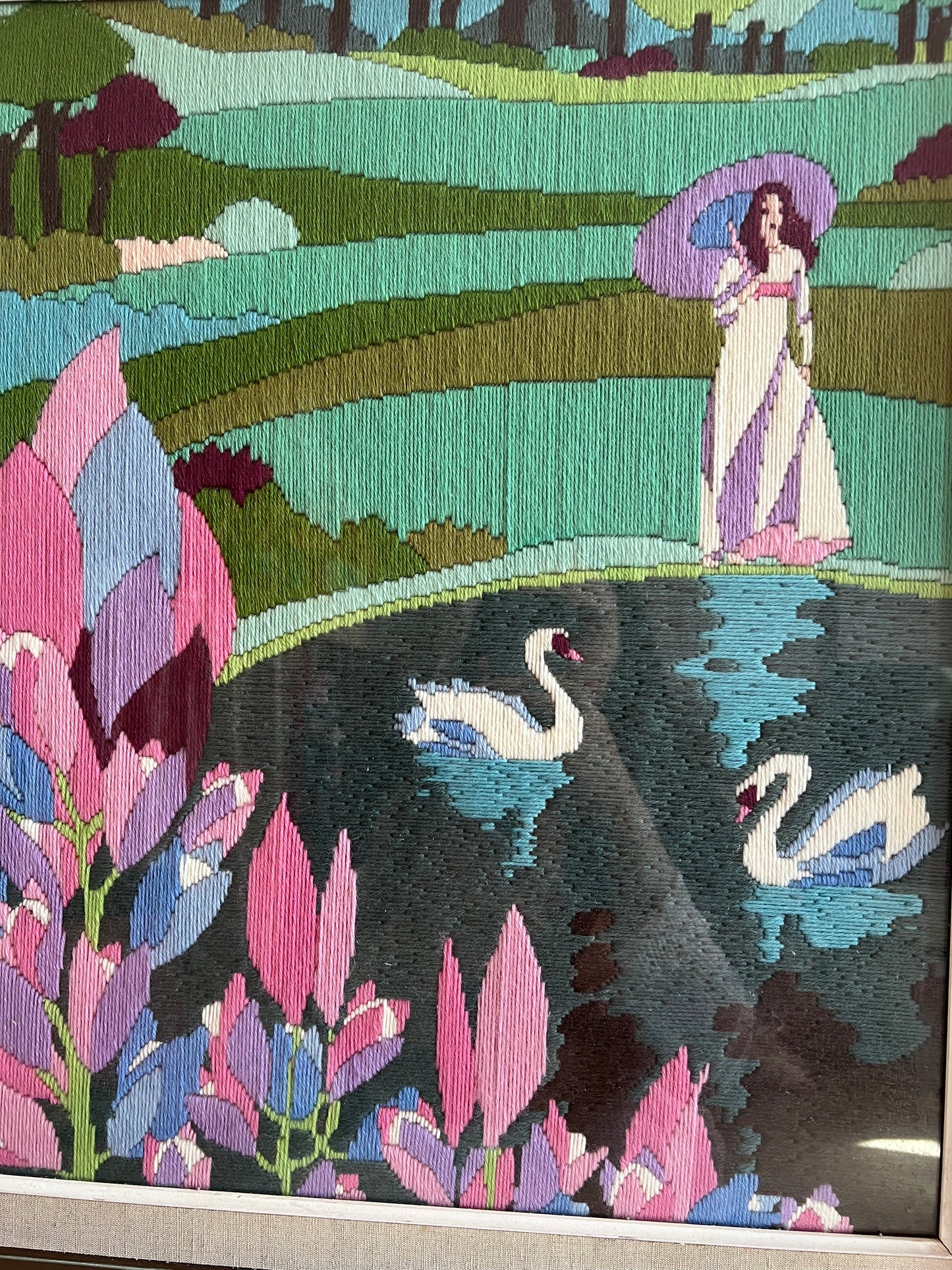 A large framed vintage swan embroidery.