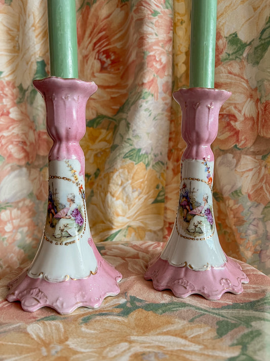 A pair of vintage pink porcelain candlestick holders.