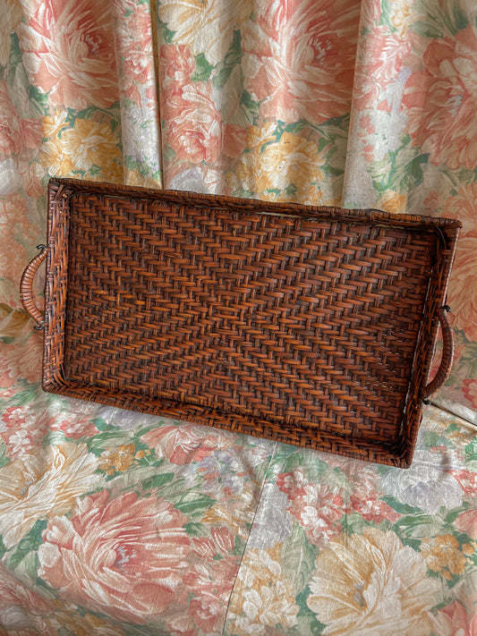 A large vintage wicker carry tray.
